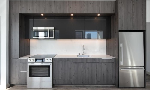 a kitchen with a refrigerator and microwave