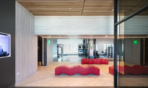 lounge room with red seating and large glass walls