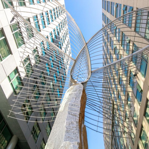 Settle into comfort at 1177 Market at Trinity Place Apartments In SoMa, CA For Rent - 1177 Market at Trinity Place - Exterior Shot Of Apartment Complex Featuring Modern Outdoo Art And Sculptures