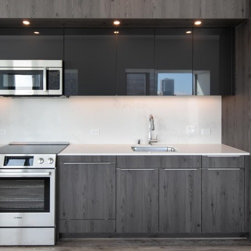 The essence of exceptional living Dog-Friendly Apartments in Sacramento, CA - 1177 Market at Trinity Place - Kitchen with Stainless-Steel Appliances and Quartz Premium Calacatta Nuvo Countertops